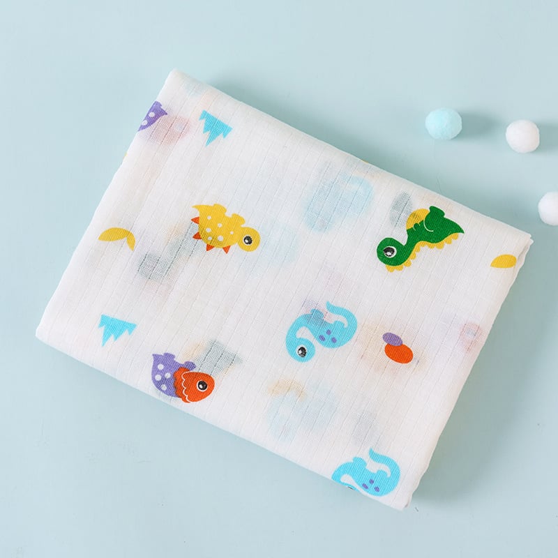Folded fabric with colorful dinosaur patterns on a light blue background