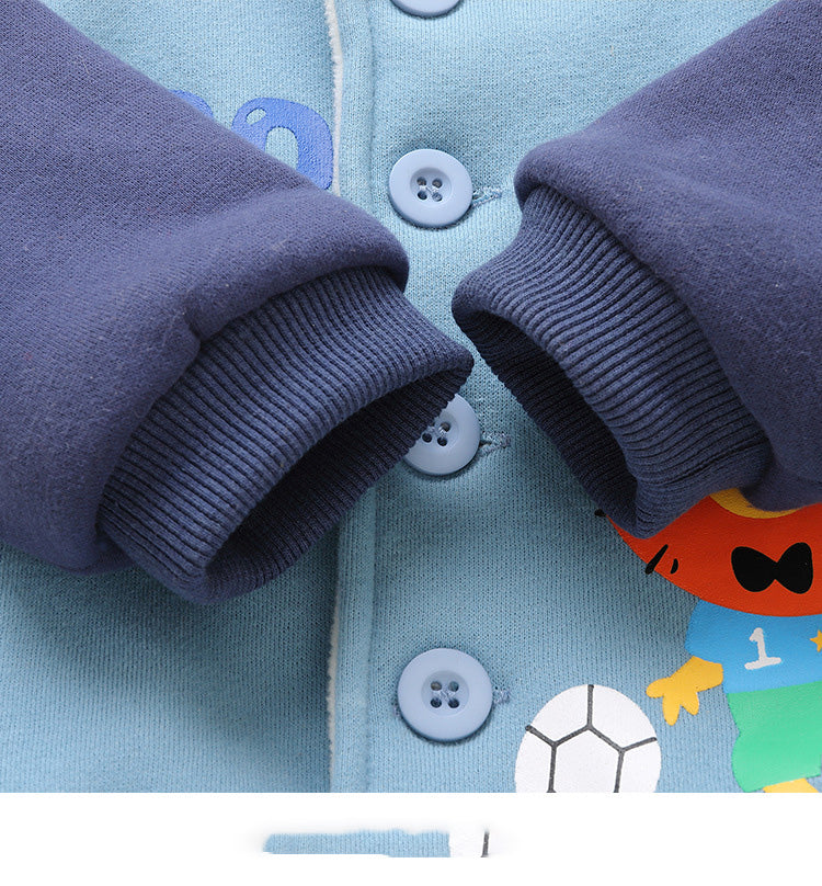 Close-up of a blue children's outfit with buttons and a cartoon character on a light blue background.
