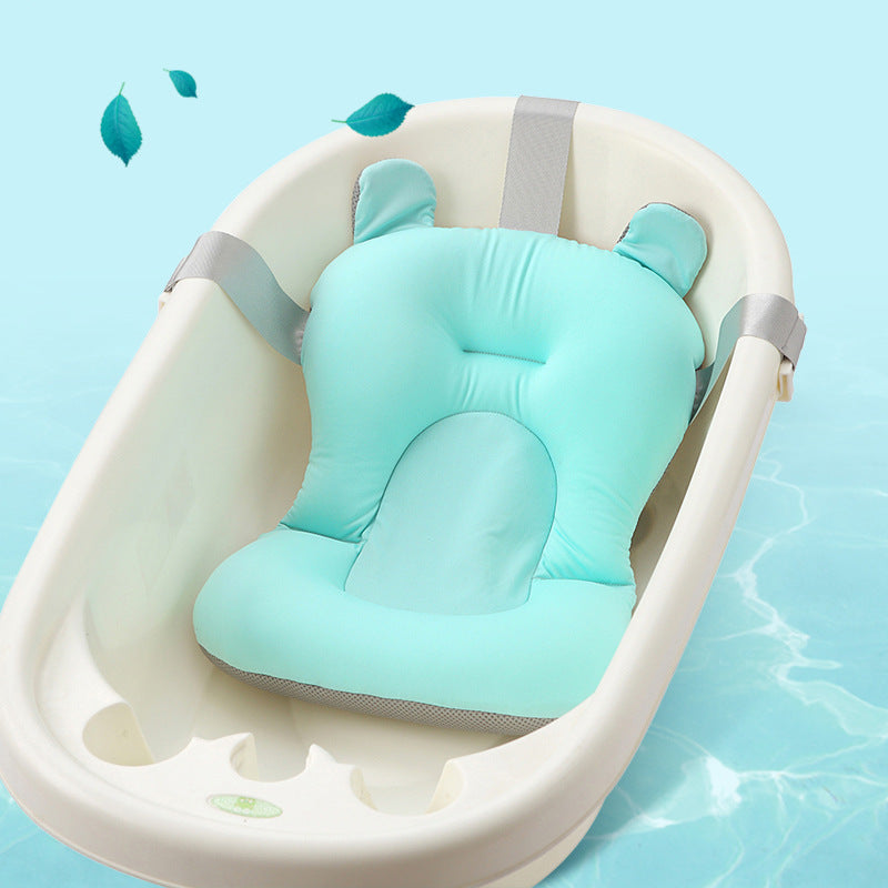 Baby bathtub with a green cushion on a blue background