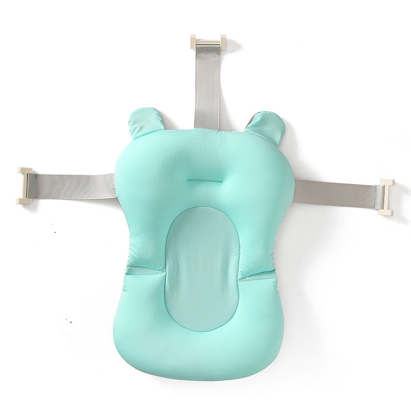 Mint green baby bath support with straps on a white background