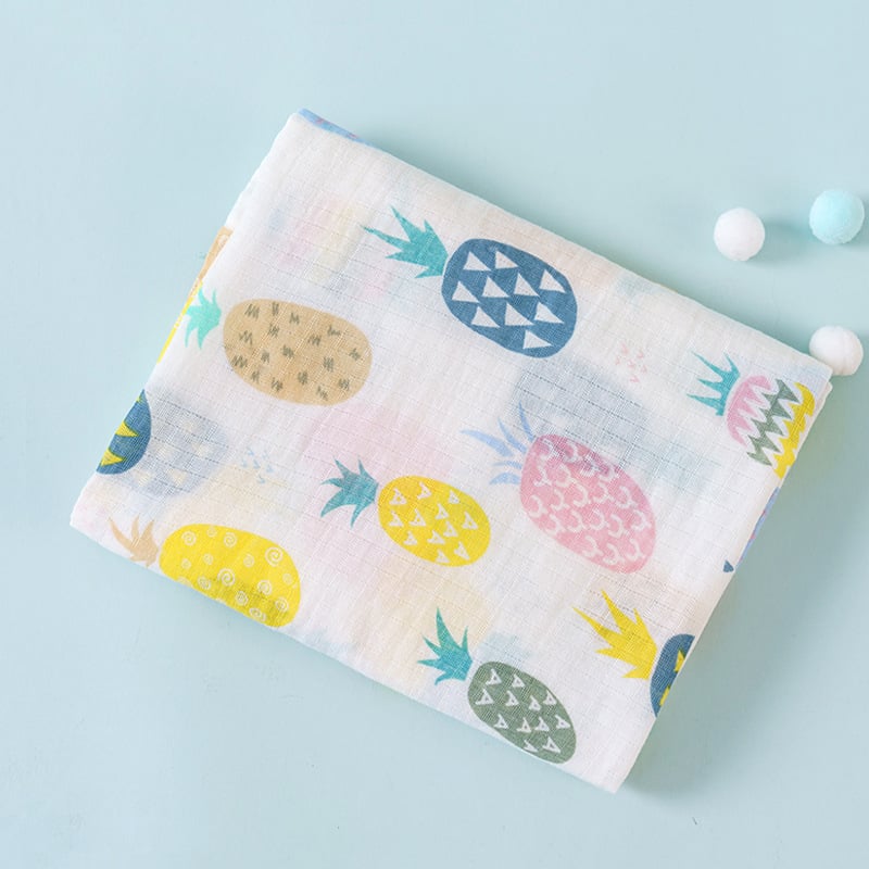 Fabric with colorful pineapple pattern on a light blue background