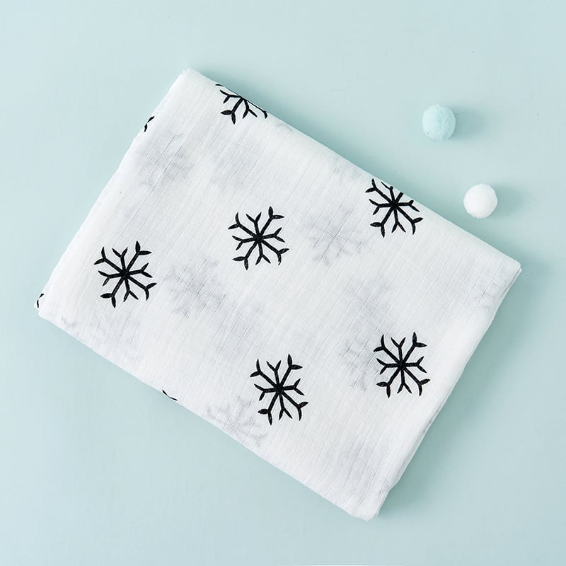 White fabric with black snowflake patterns on a light blue background