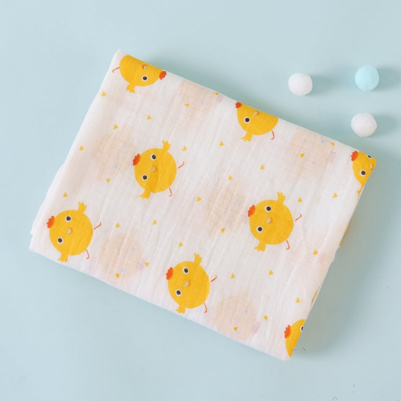 Baby blanket with yellow chick pattern on a light blue background