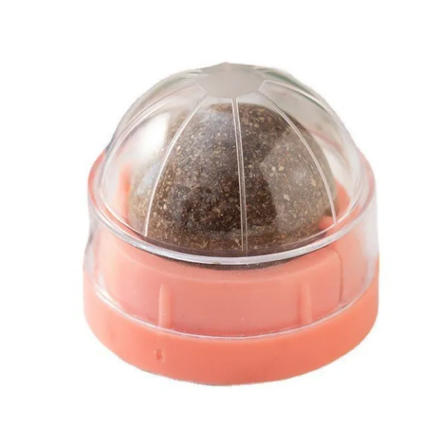 Pink and clear ball-shaped container with a textured object inside on a white background