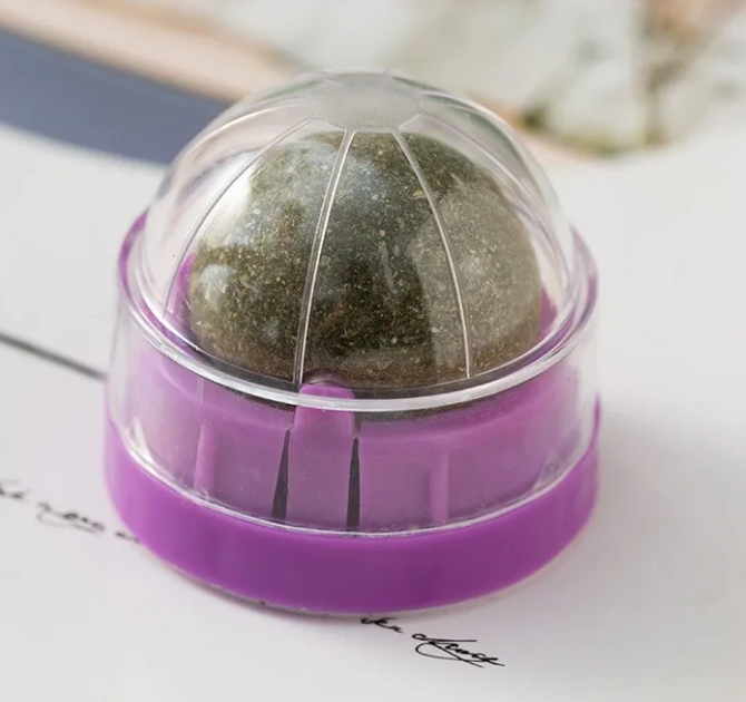 Purple and clear ball-shaped object on a white surface