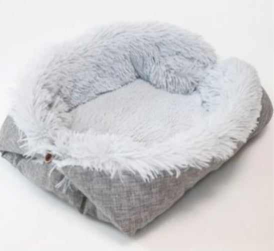 Fluffy gray pet bed with white fur on a white background