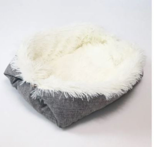 Folded blanket with gray fabric and white fluffy trim on a light background