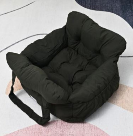 Black puffer seat cushion on a white surface
