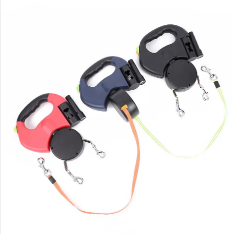 Three retractable dog leashes in different colors on a white background