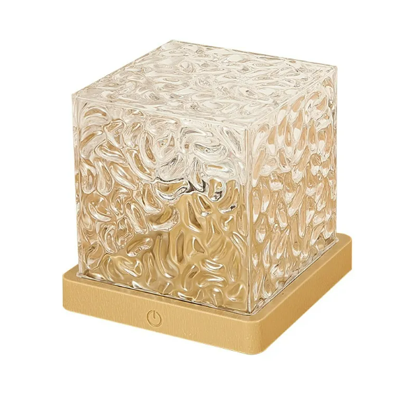 Decorative cube with textured surface on a beige base against a white background
