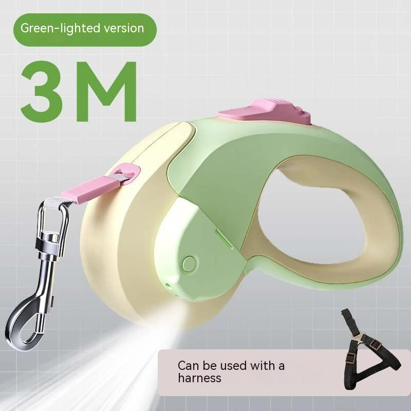 Green and beige retractable dog leash with pink handle on a white background