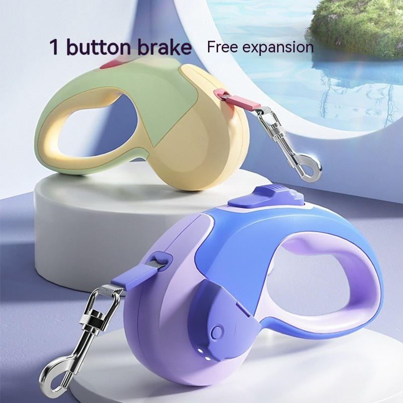 Two retractable dog leashes, one beige and one purple, with a scenic background.