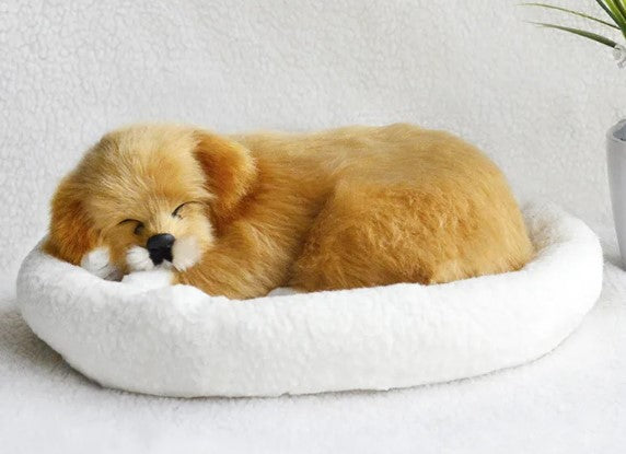 Plush toy shaped like a dog lying on a white cushion