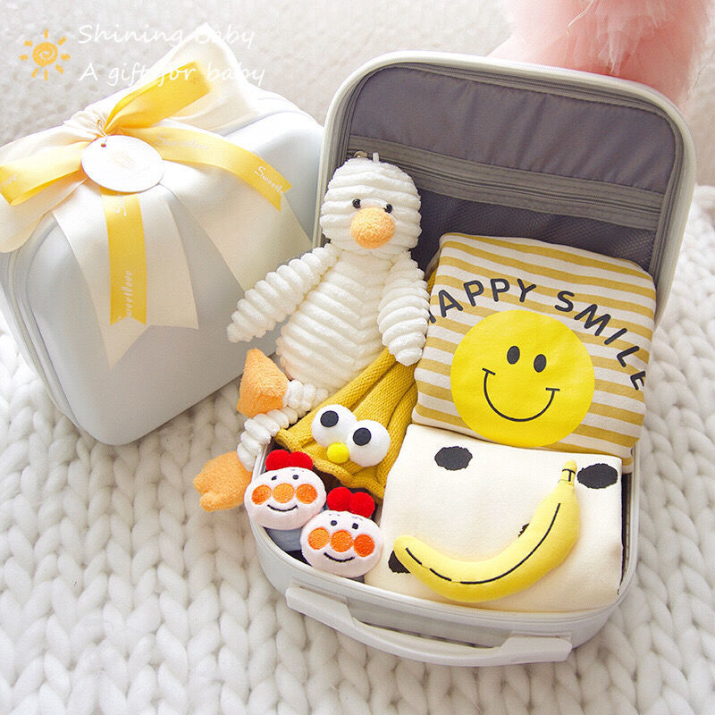 Set of plush toys and a smiley face-themed pouch on a textured surface