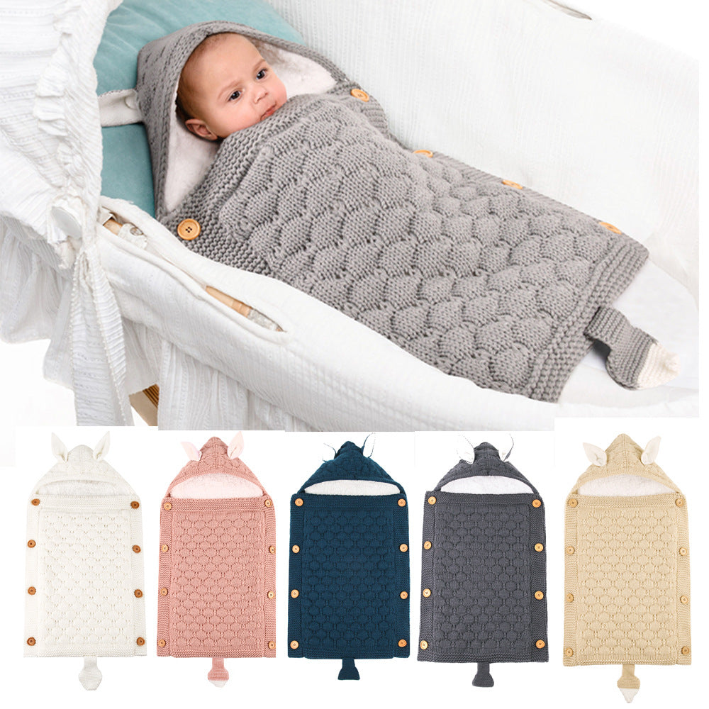 Baby swaddled in a textured gray blanket with a close-up of the product and color options below.