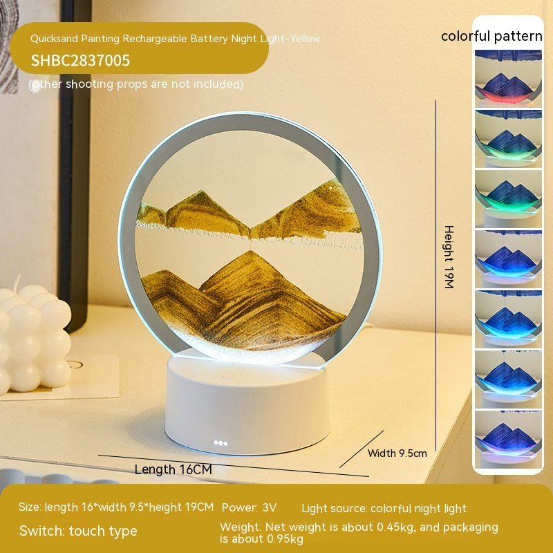 Round night light with mountain design on a white surface, surrounded by color swatches.