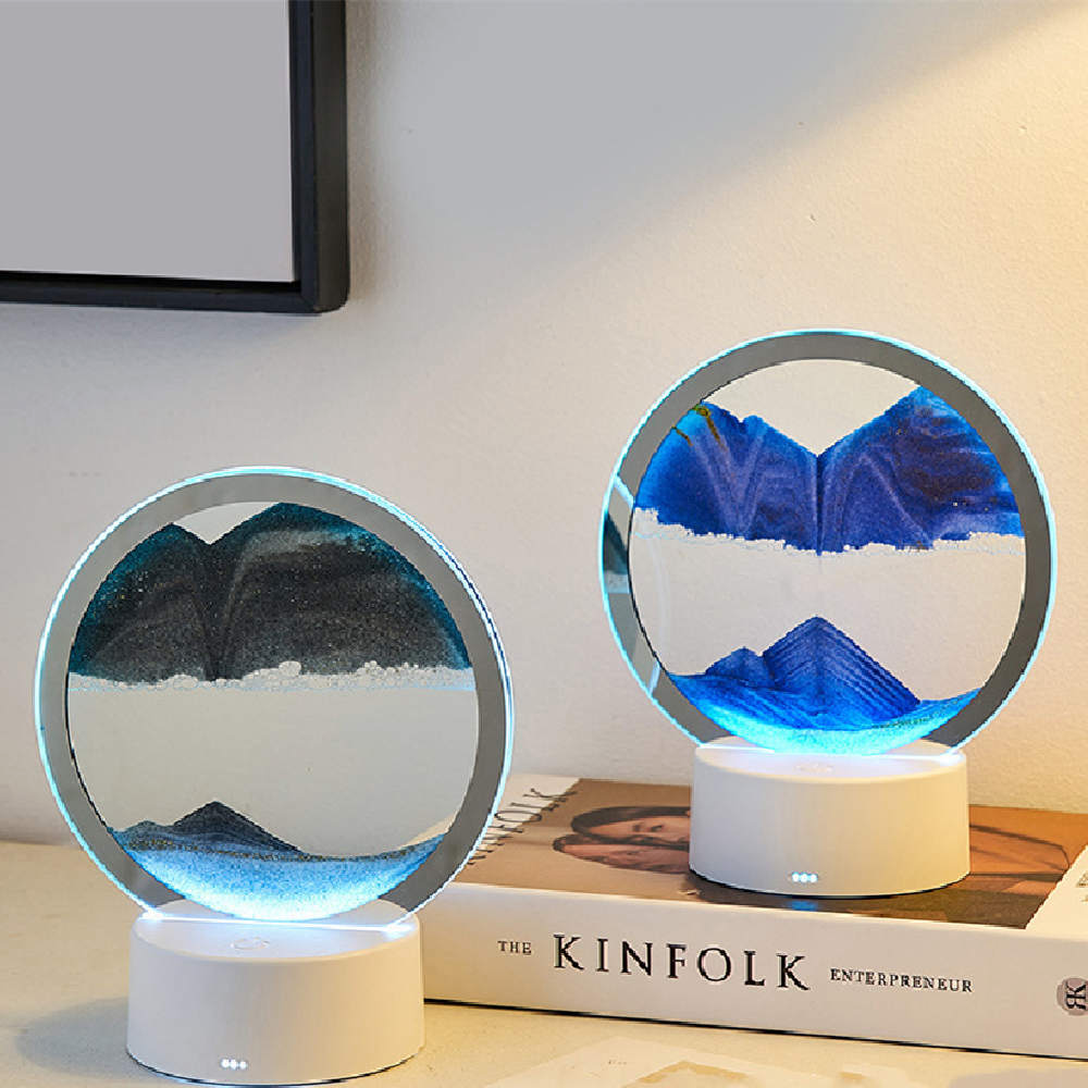 Two round LED lamps with mountain design on a book