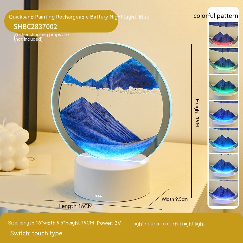 Quicksand painting rechargeable battery night light with blue mountain design on a white surface.