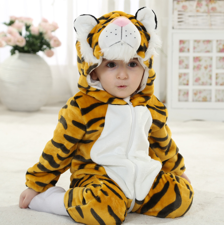 Child wearing a tiger-themed onesie in a home setting