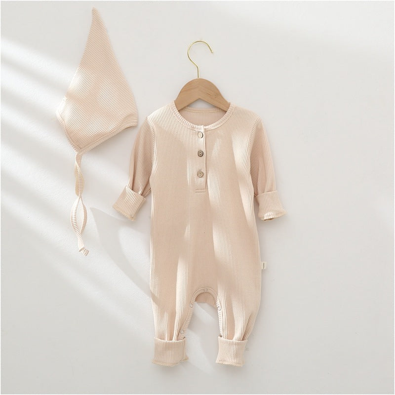 Beige baby romper with buttons and matching bonnet on a white background